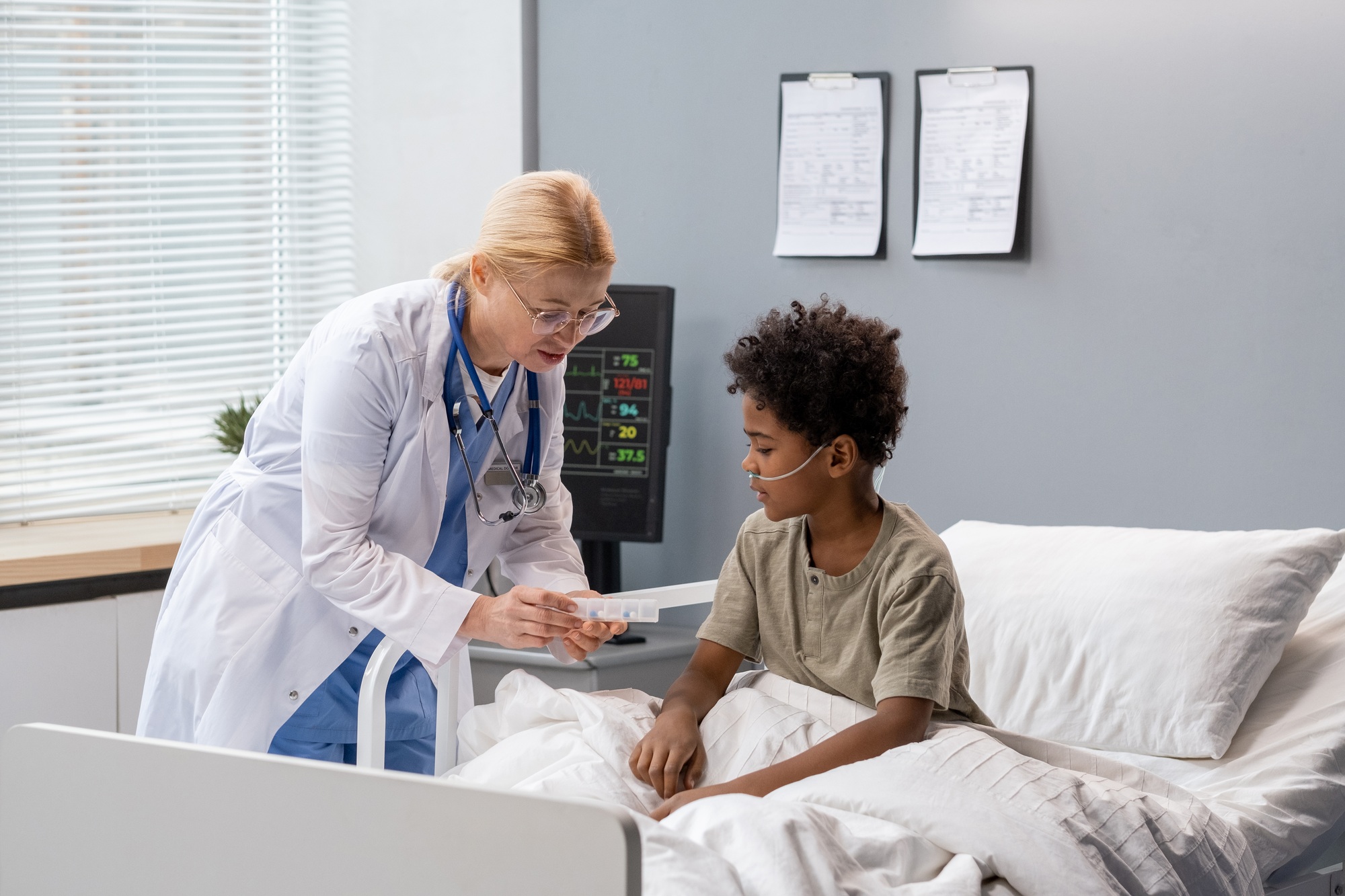 Doctor prescribing medicine to little boy