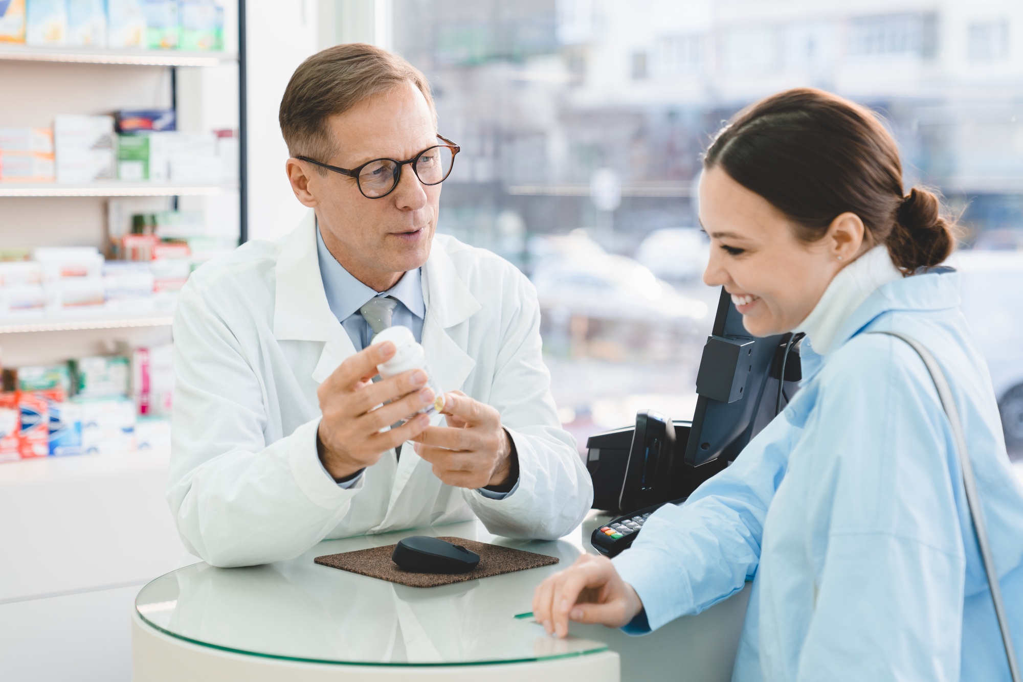 Drugstore pharmacy consultation. Druggist advising selling medicines, pills, painkillers, vitamins