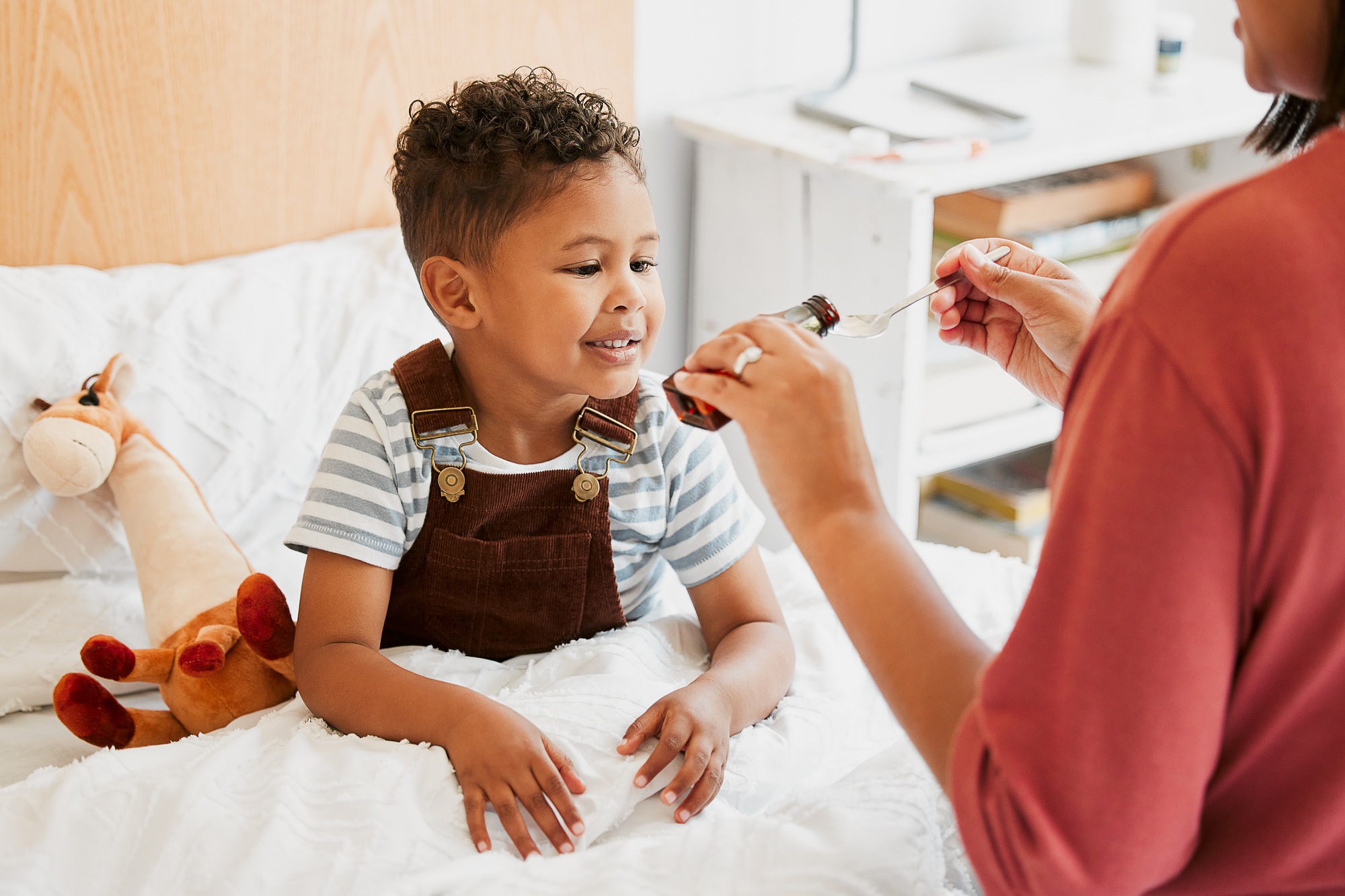 Sick child taking medicine, syrup and treatment for recovery of cold illness, flu sickness and viru